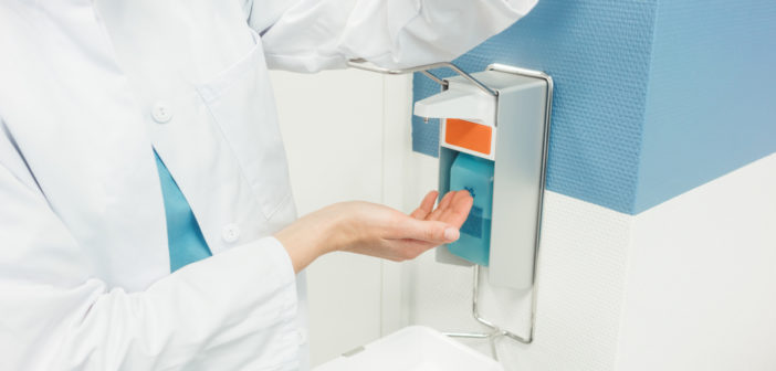 Doctor,Cleaning,And,Disinfecting,Her,Hands,In,Hospital,Diligently